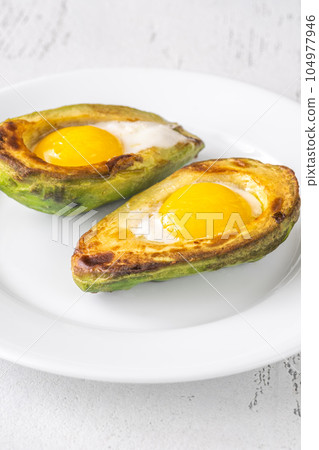 Baked eggs in avocado Baked eggs in avocado 104977946