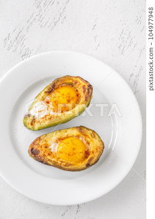 Baked eggs in avocado Baked eggs in avocado 104977948