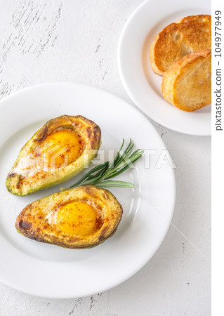 Baked eggs in avocado Baked eggs in avocado 104977949