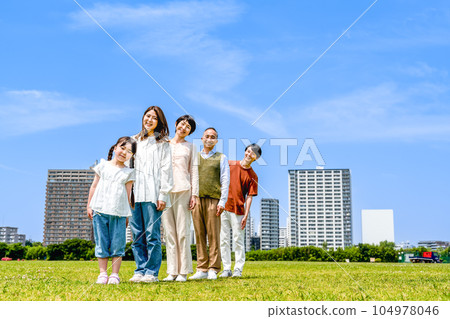 Three generations of families taking a walk in a row Three generations of families taking a walk in a row 104978046