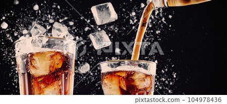 Pouring of Cola and Ice. Cola soda and ice splashing fizzing or floating up to top of surface. Close up of ice in cola water. Texture of carbonate drink with bubbles in glass. Cold drink background 104978436