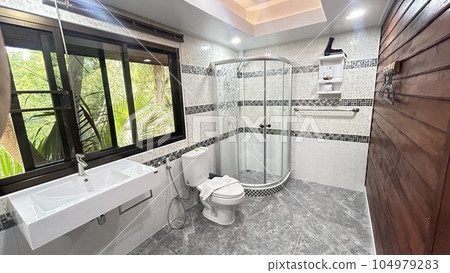Interior of a modern bathroom with shower and tile floor. Nobody inside 104979283