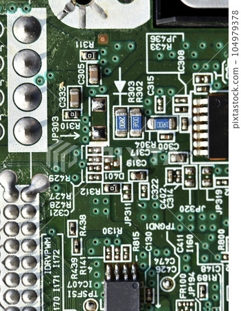 Blue board with radio elements. A chip with a processor and transistors. Diodes and resistors. Microchip. Blue board with radio elements. A chip with a processor and transistors. Diodes and resistors. Microchip. 104979378