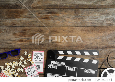 Flat lay composition with clapperboard, cinema tickets and 3d glasses on wooden table, space for text Flat lay composition with clapperboard, cinema tickets and 3d glasses on wooden table, space for text 104980271