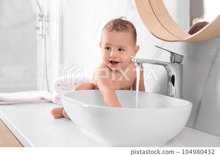 Cute little baby playing in bathroom at home 104980432