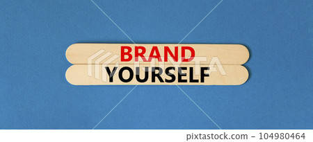 Brand yourself symbol. Concept words Brand yourself on beautiful wooden stick. Beautiful blue table blue background. Business brand yourself concept. Copy space. Brand yourself symbol. Concept words Brand yourself on beautiful wooden stick. Beautiful blue table blue background. Business brand yourself concept. Copy space. 104980464