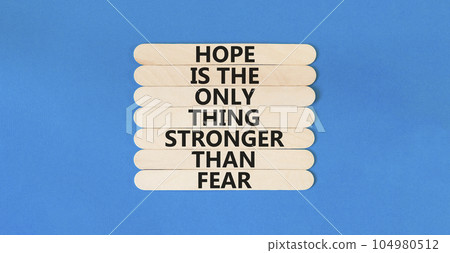 Hope stronger than fear symbol. Concept words Hope is the only thing stronger than fear on wooden stick on beautiful blue table blue background. Business motivational hope stronger than fear concept. Hope stronger than fear symbol. Concept words Hope is the only thing stronger than fear on wooden stick on beautiful blue table blue background. Business motivational hope stronger than fear concept. 104980512