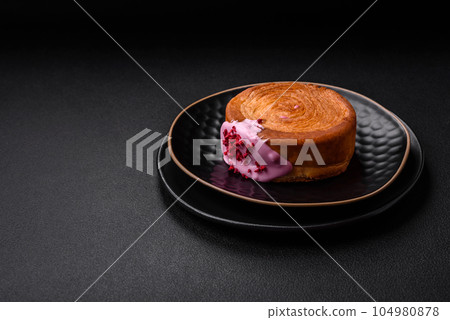 Round puff pastry croissant with raspberry filling or new york roll Round puff pastry croissant with raspberry filling or new york roll 104980878