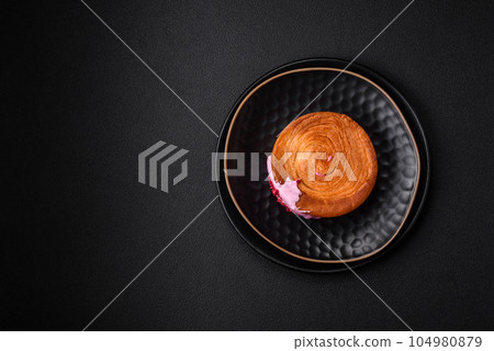 Round puff pastry croissant with raspberry filling or new york roll Round puff pastry croissant with raspberry filling or new york roll 104980879