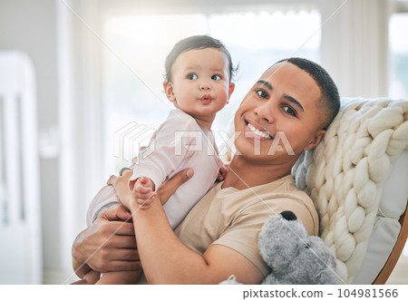 Shes my everything. a handsome young man and his newborn baby at home. 104981566