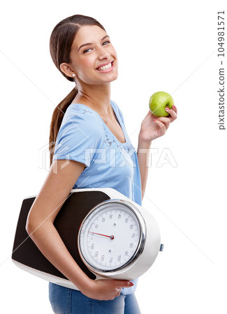 Apple, scale and diet of woman isolated on white background in studio health, lose weight and portrait. Green fruit, healthy goals and model smile for detox results, food or wellness marketing mockup 104981571