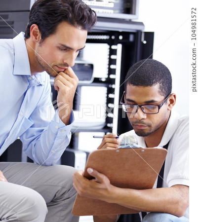 Teamwork, IT and men with clipboard in server room for maintenance, inspection and fixing. Checklist, network technician and tech support for cybersecurity, information and help in data center. Teamwork, IT and men with clipboard in server room for maintenance, inspection and fixing. Checklist, network technician and tech support for cybersecurity, information and help in data center. 104981572