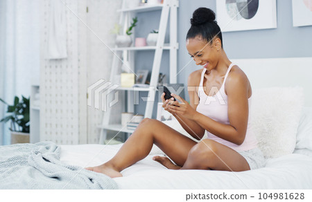 Phone, happy and woman in bed laughing for social media post, internet humor and funny text message. Communication, home and female person in bedroom on smartphone for mobile app, website and online 104981628