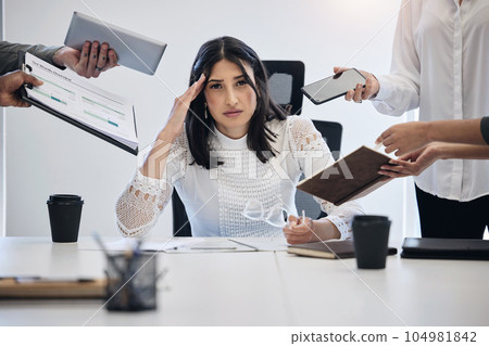 When can I leave. Shot of a young businesswoman looking stressed out in a demanding work environment. When can I leave. Shot of a young businesswoman looking stressed out in a demanding work environment. 104981842