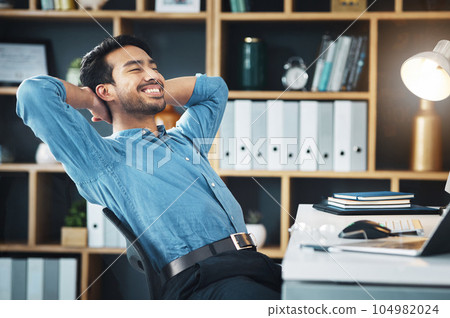 Happy business man, eyes closed and stretching to relax from easy project, dream and happiness in office. Worker, smile and hands behind head to finish tasks, rest and break for inspiration at desk 104982024