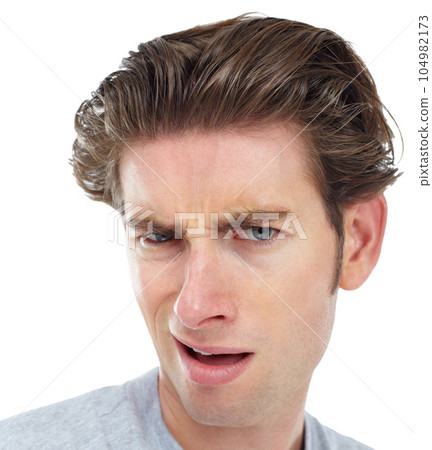 Confused, closeup and portrait of man in studio for frustrated, disgusted and doubt. Goofy, displeased and unhappy with face of male isolated on white background for wow, funny and crazy expression Confused, closeup and portrait of man in studio for frustrated, disgusted and doubt. Goofy, displeased and unhappy with face of male isolated on white background for wow, funny and crazy expression 104982173