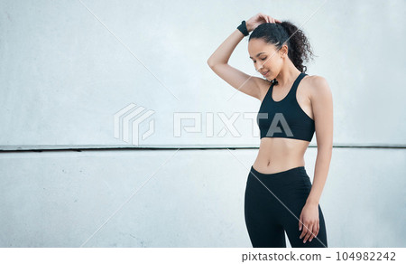 Putting in the work. Cropped shot of an attractive young female athlete exercising outside in the city. Putting in the work. Cropped shot of an attractive young female athlete exercising outside in the city. 104982242