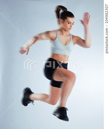 Time to level up. Full length shot of an attractive young female athlete posing in studio against a grey background. 104982307