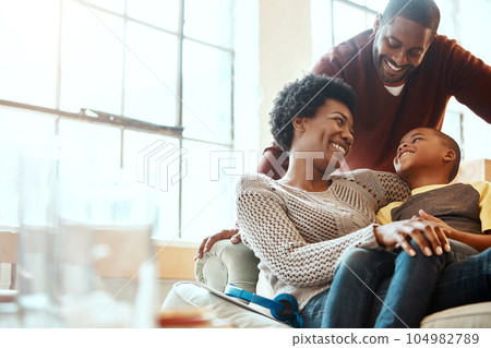Happy, love and family bonding on a sofa together in the living room of their modern house. Happiness, smile and African parents spending quality time, talking and relaxing with her boy child at home 104982789