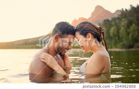 Lake, swim or happy couple love bonding on outdoor holiday vacation adventure or weekend together. Travel, forehead or woman smiling or swimming with freedom, peace or romantic man in river water 104982808