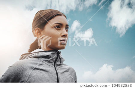 Sky, runner and Indian woman with focus, training and exercise with workout goal, target and balance. Female person, mockup space and athlete with wellness, concentration and energy with cardio 104982888