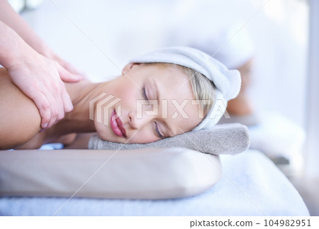 Woman getting massage in spa, wellness and hands of masseuse with peace, tranquility and holistic treatment. Stress relief, zen and female person at luxury resort with self care and body healing Woman getting massage in spa, wellness and hands of masseuse with peace, tranquility and holistic treatment. Stress relief, zen and female person at luxury resort with self care and body healing 104982951