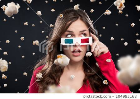 Its raining kernels. Shot of a young woman wearing 3D glasses against a studio background. Its raining kernels. Shot of a young woman wearing 3D glasses against a studio background. 104983168