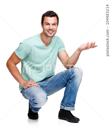 Portrait, space and hand gesture with a man in studio isolated on a white background for marketing or advertising. Product, branding and mock up with a handsome young male posing to promote a brand Portrait, space and hand gesture with a man in studio isolated on a white background for marketing or advertising. Product, branding and mock up with a handsome young male posing to promote a brand 104983214