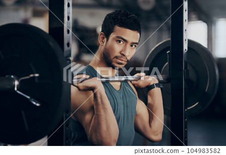 Man, portrait and push press barbell for workout at the gym for strong muscles in a close up. Male athlete, exercise and weight lift for fitness at a club with equipment for healthy body with cardio. 104983582