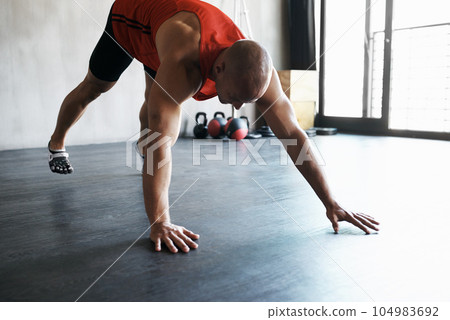 Workout, gym and man doing floor exercise, health commitment and athletic training for muscle building growth. Fitness club, healthy body or strong person, bodybuilder or athlete doing floor push up 104983692