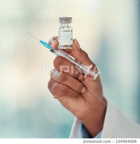 Healthcare, close hand of doctor with syringe and covid vaccine at a hospital. Medication, treatment and nurse or surgeon hands with medical injection needle for health wellness for corona virus 104984006