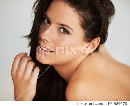 Portrait, beauty and sensuality with a model woman in studio on a white background for natural skincare. Face, happy and feminine with an attractive young female person posing for luxury treatment 104984078