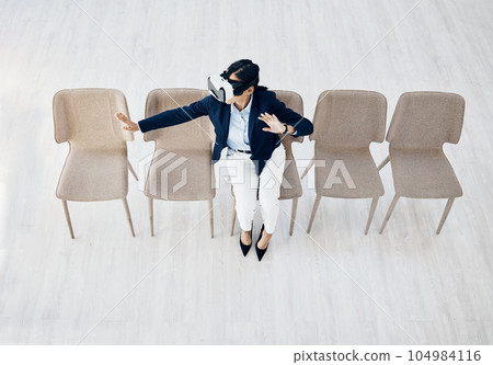 Business woman, vr headset and sitting cyber game with professional in office with innovation work. Virtual reality glasses, female employee and above view with ai, 3d and future platform at job 104984116