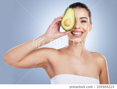 Avocado, skincare and portrait of latino woman in studio happy with detox, wellness or omega 3 treatment on grey background. Fruit, face and lady model smile for anti aging or vitamin c facial beauty Avocado, skincare and portrait of latino woman in studio happy with detox, wellness or omega 3 treatment on grey background. Fruit, face and lady model smile for anti aging or vitamin c facial beauty 104984224