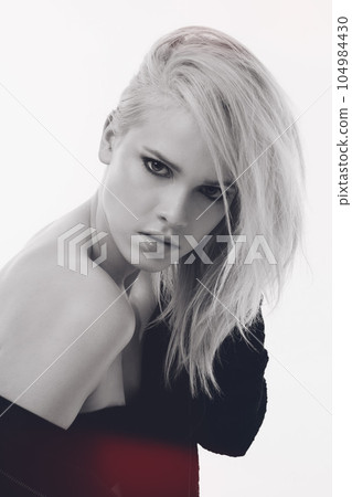 Fashion, creative and portrait of woman in studio for monochrome, black and white style. Trendy, edgy and confident with face of female model isolated on white background for beauty and aesthetic 104984430