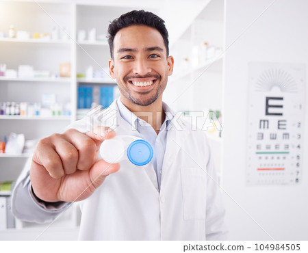 Happy asian man, doctor and contact lenses at pharmacy for sight, vision or healthcare solution at store. Portrait of male person, pharmacist or medical professional smile with eye case at the clinic Happy asian man, doctor and contact lenses at pharmacy for sight, vision or healthcare solution at store. Portrait of male person, pharmacist or medical professional smile with eye case at the clinic 104984505