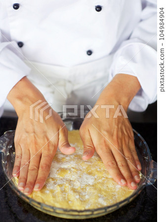 Baker, hands and press pie dough for dessert, cake or meringue in kitchen job for fine dining. Person, cooking and professional pastry chef in cafe, coffee shop and small business for sweet food 104984904