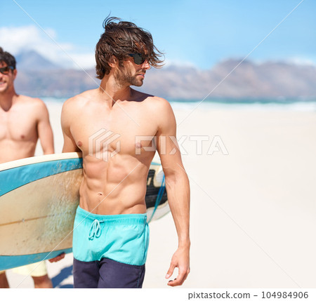 Beach, body and man surfing friends outdoor together for travel, vacation or holiday trip overseas. Surf, sea or summer with a shirtless male surfer in sunglasses and friend bonding on an ocean coast 104984906