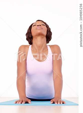 Woman, yoga and stretching in fitness for zen, spiritual wellness or pilates workout on the mat. African female yogi in svanasana pose for healthy body, relax or warm up stretch in training exercise Woman, yoga and stretching in fitness for zen, spiritual wellness or pilates workout on the mat. African female yogi in svanasana pose for healthy body, relax or warm up stretch in training exercise 104985256