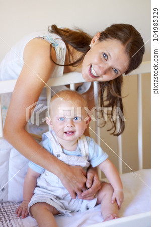 Happy family, portrait of a woman with her baby and in a crib of their home together with a smile. Happiness or development, love or care and mother with her child in a bedroom of their house 104985329