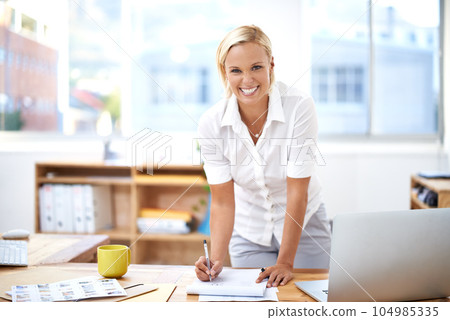 Success, smile and portrait of a businesswoman in her office writing on paper for startup planning. Confidence, happy and professional female hr manager working on a company report in the workplace. 104985335