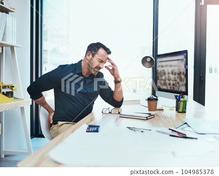 Businessman with back pain, injury and headache from stress in the office while working on project. Medical emergency, healthcare and mature male employee with migraine and sprain muscle in workplace Businessman with back pain, injury and headache from stress in the office while working on project. Medical emergency, healthcare and mature male employee with migraine and sprain muscle in workplace 104985378
