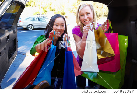 Car, bags and travel of friends shopping in a city, happy and having fun at retail sale. Taxi, portrait and faces of women at mall for store discount, items and boutique packages, smile and excited 104985387