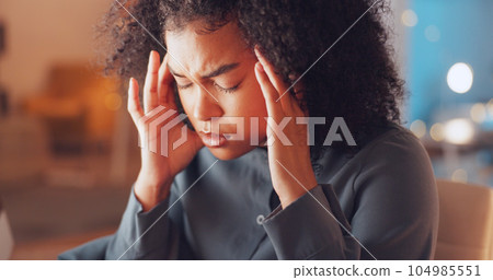 Burnout, night and woman with a headache in the office while working on a deadline corporate project. Stress, migraine and tired professional female business employee with frustration in workplace. 104985551