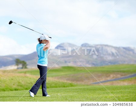 Driver, girl or golfer playing golf for fitness, workout or exercise with a swing on a green course. Wellness, woman golfing or athlete training in action or sports game driving with a club stroke 104985638