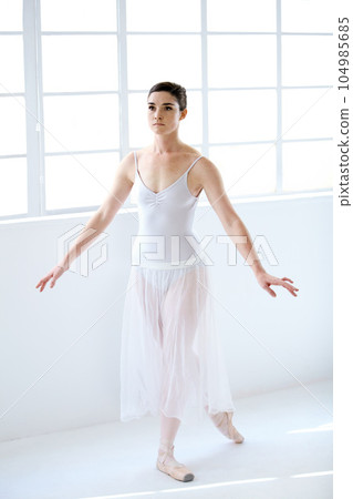 Dance, ballet and focus with woman in studio for balance, elegant and performance. Artist, theatre and training with female ballerina dancing in class for competition, freedom and commitment Dance, ballet and focus with woman in studio for balance, elegant and performance. Artist, theatre and training with female ballerina dancing in class for competition, freedom and commitment 104985685