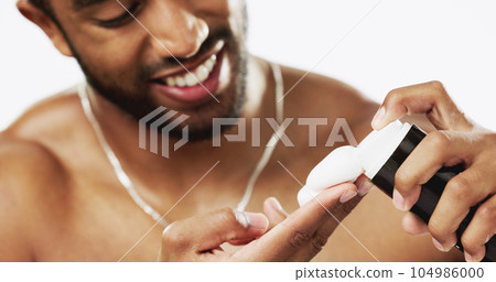 Skincare, cosmetics and man with shaving cream, grooming and hygiene against a grey studio background. Latino male, happy guy and facial foam for hair removal, wellness and product for beard and face 104986000