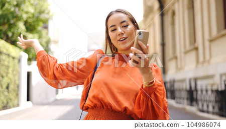 Asian woman, phone and talking on video call in city, live streaming or vlogging. Influencer, cellphone and person on virtual chat in urban street, speaking or discussion outdoor for content creation 104986074