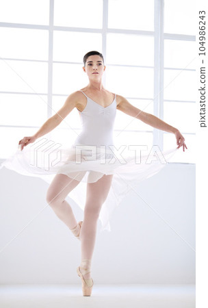 Dance, ballet and talent with woman in studio for balance, elegant and performance. Artist, theatre and training with female ballerina dancing in class for competition, freedom and commitment 104986243