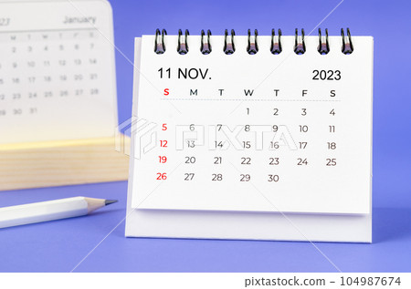 The November 2023 Monthly desk calendar for 2023 year with pencil on purple background. The November 2023 Monthly desk calendar for 2023 year with pencil on purple background. 104987674